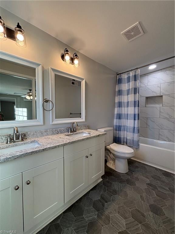 full bathroom with shower / bath combo, vanity, toilet, and ceiling fan