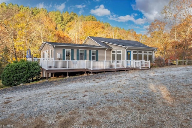 back of property with a wooden deck