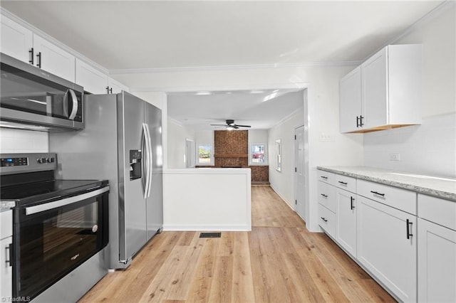 kitchen with white cabinets, appliances with stainless steel finishes, light hardwood / wood-style flooring, and ceiling fan