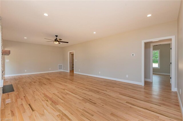 unfurnished living room featuring a ceiling fan, visible vents, light wood-type flooring, baseboards, and recessed lighting