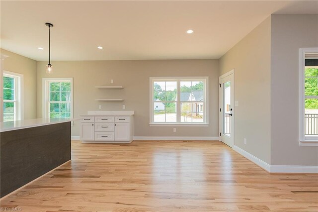 interior space featuring light wood-style floors, recessed lighting, baseboards, and a wealth of natural light
