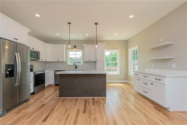 kitchen featuring appliances with stainless steel finishes, open shelves, light countertops, white cabinets, and light wood-style floors