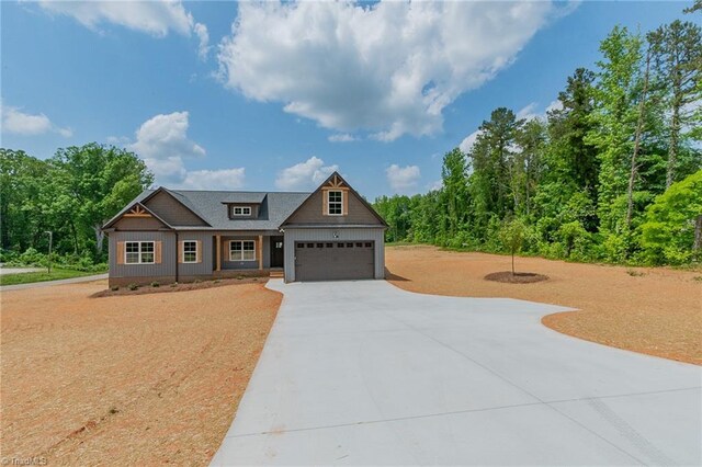 craftsman inspired home with concrete driveway and an attached garage