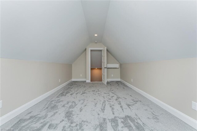 bonus room featuring carpet floors, baseboards, a wall mounted air conditioner, recessed lighting, and vaulted ceiling