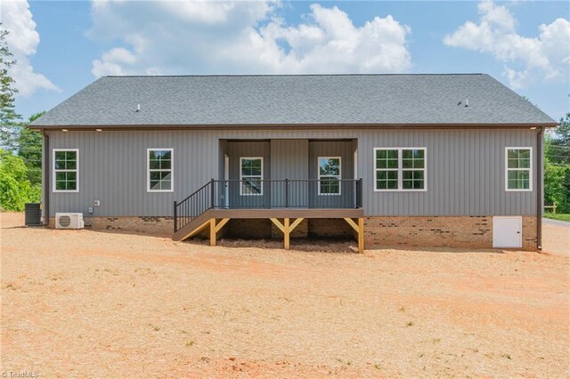 back of property with roof with shingles, central AC unit, ac unit, and crawl space