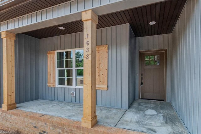 doorway to property featuring board and batten siding