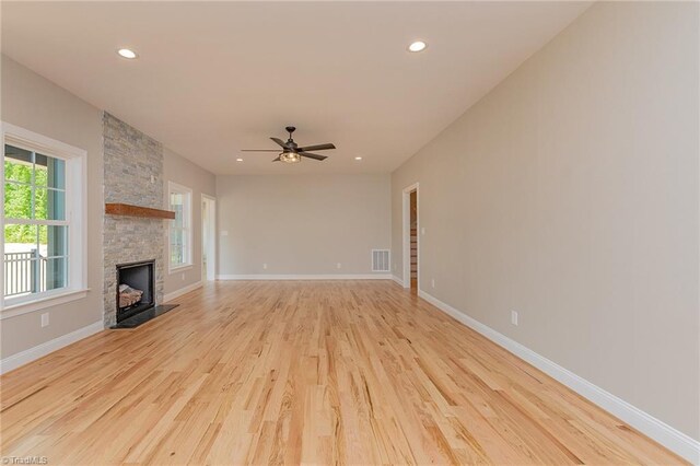 unfurnished living room with recessed lighting, a fireplace, light wood-type flooring, and visible vents