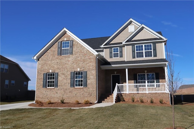 view of front facade featuring covered porch and a front lawn