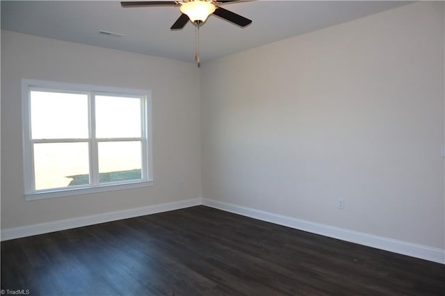 empty room featuring ceiling fan and dark hardwood / wood-style flooring