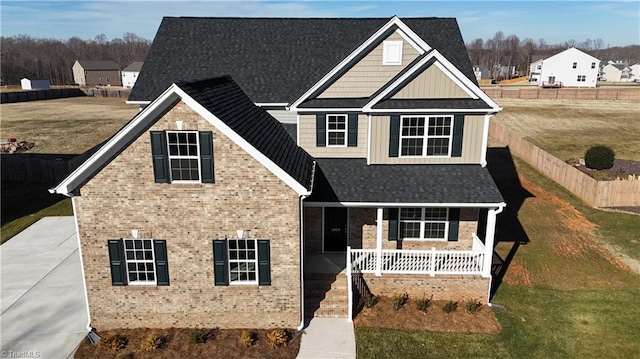 view of front of home with covered porch and a front lawn