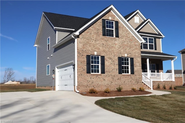 view of front facade with a garage, a front lawn, and covered porch