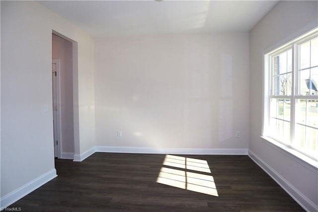 unfurnished room with dark hardwood / wood-style floors