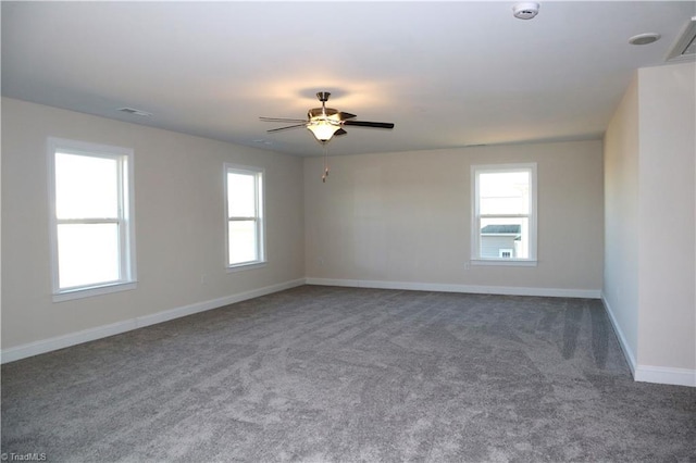 carpeted spare room featuring ceiling fan