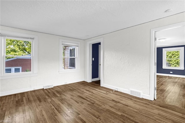 608 Spruce St, High Point, NC 27262 - empty room with a textured ceiling, wood finished floors, a textured wall, and a smoke detector