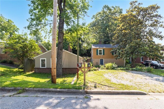 608 Spruce St, High Point, NC 27262 - view of front of home with a front yard and a chimney