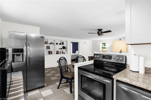 608 Spruce St, High Point, NC 27262 - kitchen with appliances with stainless steel finishes, ceiling fan, white cabinetry, light floors, and light stone counters