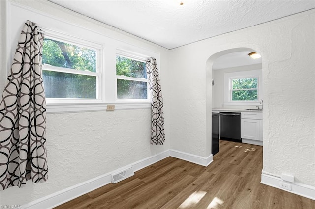 608 Spruce St, High Point, NC 27262 - spare room with a textured wall, arched walkways, dark wood-style floors, and a textured ceiling