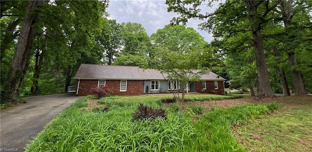 ranch-style home with brick siding and aphalt driveway