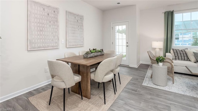 dining space with hardwood / wood-style floors