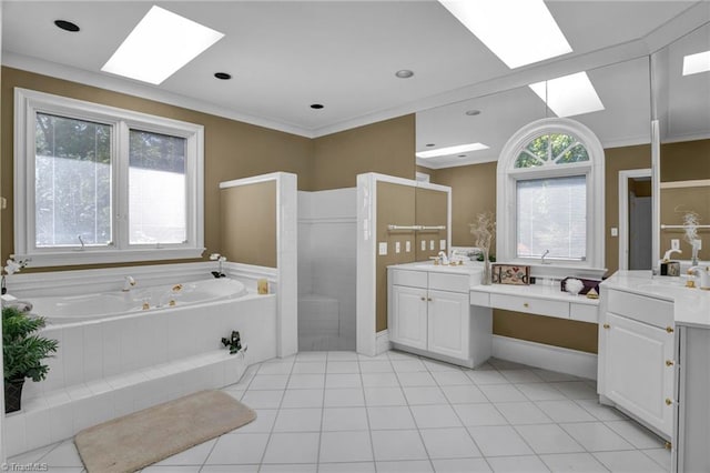 bathroom featuring tile patterned flooring, vanity, a skylight, and a relaxing tiled tub