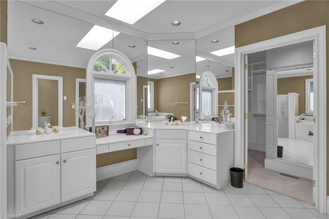 bathroom with ornamental molding, tile patterned flooring, vanity, and a skylight