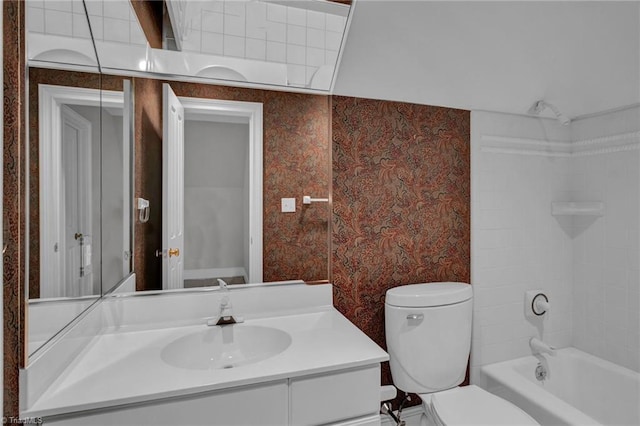 1902 Rockglen Ln, Greensboro, NC 27410 - bathroom featuring wallpapered walls, vanity, toilet, and tub / shower combination