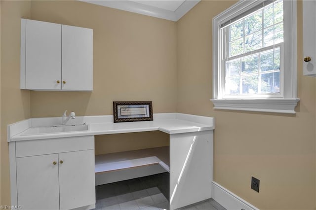 unfurnished office with light tile patterned flooring and sink