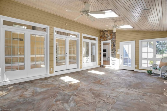 unfurnished sunroom featuring french doors, ceiling fan, wooden ceiling, and lofted ceiling with skylight