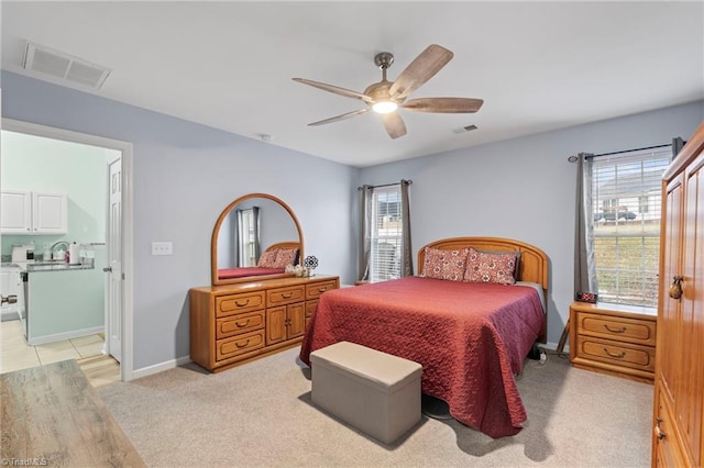 carpeted bedroom featuring multiple windows and ceiling fan