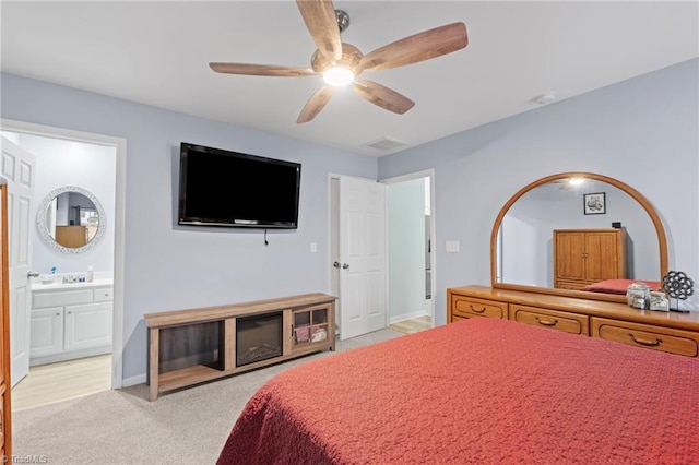 carpeted bedroom featuring ceiling fan and ensuite bathroom