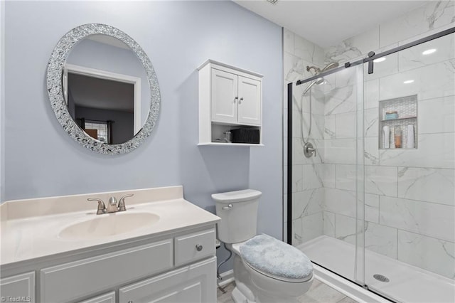 bathroom featuring toilet, an enclosed shower, and vanity