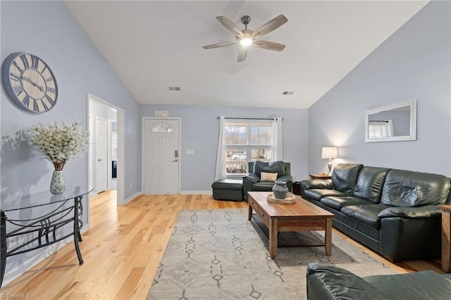 living room featuring ceiling fan, vaulted ceiling, and light hardwood / wood-style flooring