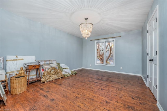 interior space with dark wood-type flooring and a notable chandelier