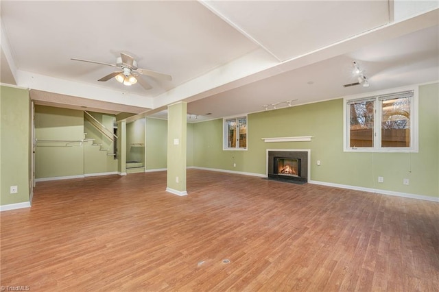 unfurnished living room with wood-type flooring and ceiling fan