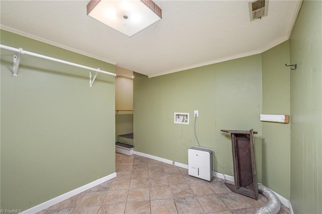 washroom with crown molding, light tile patterned floors, and hookup for a washing machine