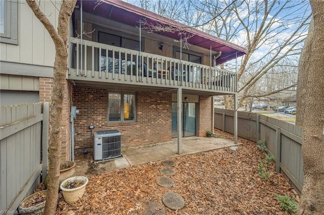 back of property featuring central AC, a balcony, and a patio area