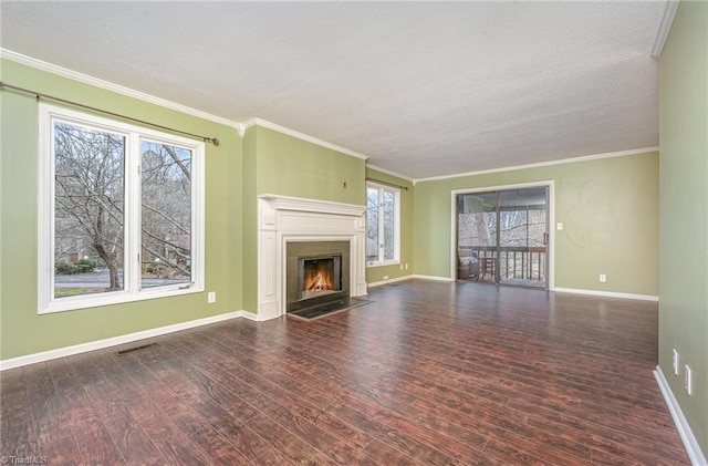 unfurnished living room with hardwood / wood-style flooring and crown molding