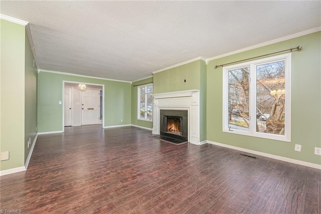 unfurnished living room featuring plenty of natural light, dark hardwood / wood-style flooring, and a textured ceiling