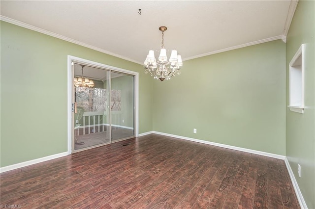 empty room featuring hardwood / wood-style flooring, ornamental molding, and a chandelier