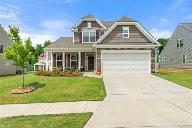 4077 Glenn Knoll Ln, Winston-Salem, NC 27107 - craftsman-style house featuring a front yard, covered porch, concrete driveway, stone siding, and an attached garage