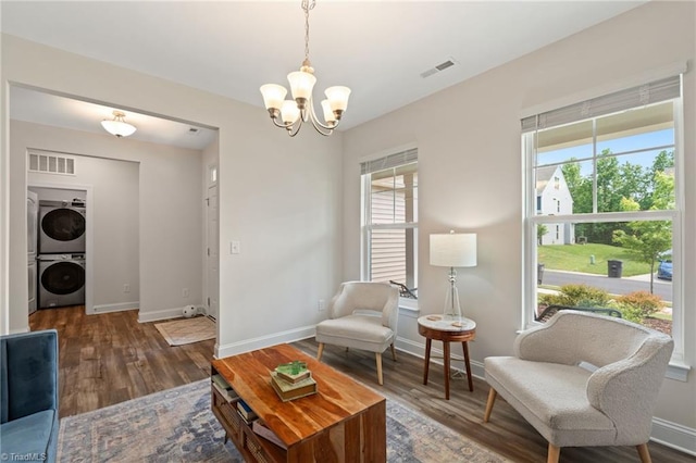 4077 Glenn Knoll Ln, Winston-Salem, NC 27107 - living area with stacked washer and clothes dryer, a chandelier, baseboards, and wood finished floors