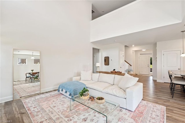 4077 Glenn Knoll Ln, Winston-Salem, NC 27107 - living area with baseboards, wood finished floors, a high ceiling, and stairs