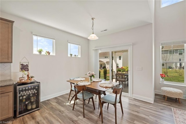 4077 Glenn Knoll Ln, Winston-Salem, NC 27107 - dining space featuring beverage cooler, light wood-style floors, and baseboards