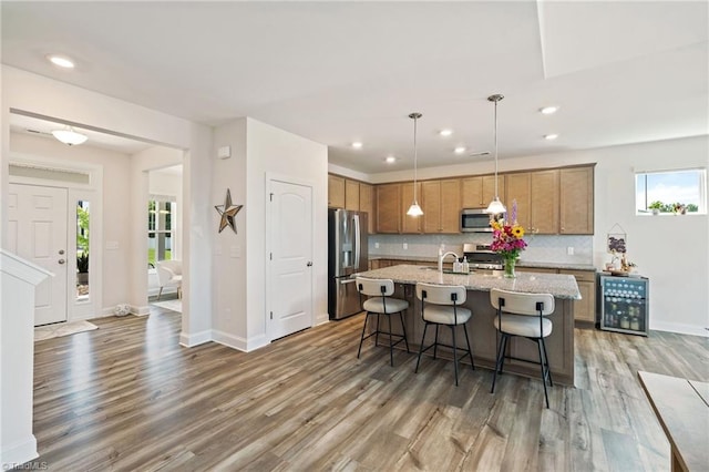 4077 Glenn Knoll Ln, Winston-Salem, NC 27107 - kitchen featuring appliances with stainless steel finishes, wine cooler, light wood finished floors, decorative backsplash, and baseboards