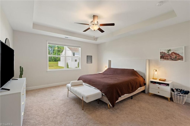 4077 Glenn Knoll Ln, Winston-Salem, NC 27107 - bedroom featuring a raised ceiling, light colored carpet, a ceiling fan, and baseboards