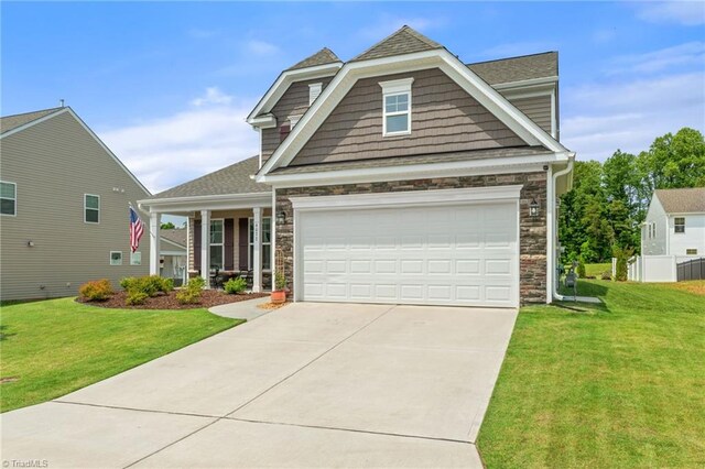 4077 Glenn Knoll Ln, Winston-Salem, NC 27107 - view of front facade featuring stone siding, concrete driveway, a front lawn, and roof with shingles