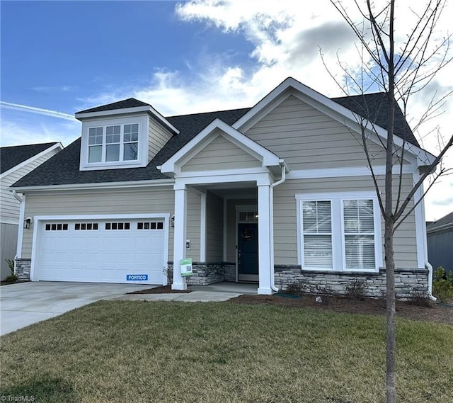 view of front of home with a garage and a front lawn