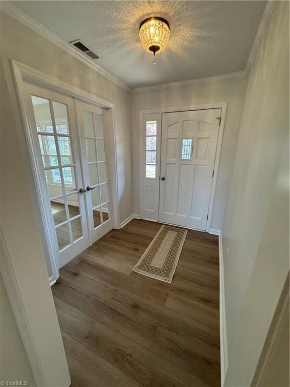 entryway featuring visible vents, crown molding, french doors, dark wood-style floors, and a textured ceiling