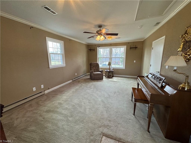 sitting room with a baseboard radiator, carpet, visible vents, and crown molding