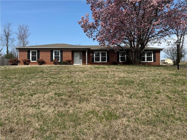 ranch-style house with brick siding and a front lawn